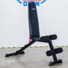 Vitox Fitness - Adjustable FID bench VB115, with a padded seat and backrest, shown in multiple positions (flat, incline, decline), with leg holder foam. Features a sturdy frame and adjustable settings for versatile workouts.