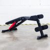 Vitox Fitness - Adjustable FID bench VB115, with a padded seat and backrest, shown in multiple positions (flat, incline, decline), with leg holder foam. Features a sturdy frame and adjustable settings for versatile workouts.