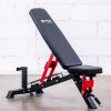 Vitox Fitness-Adjustable commercial utility bench VB177 with black padding and a sturdy steel frame. The bench features an adjustable backrest and seat, allowing for various incline, flat, and decline positions. Designed for heavy-duty use in commercial gyms or home settings, this bench is ideal for strength training exercises like presses and rows. The compact design includes a handle and wheels for easy mobility.